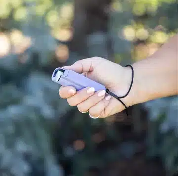 Black pepper spray canister in a textured holster with clip