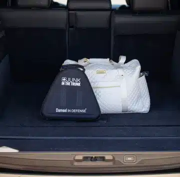 Roadside emergency kit contents laid out, including reflective triangle, gloves and tools