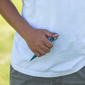 Keychain with a black teardrop personal alarm and a slim safety tool