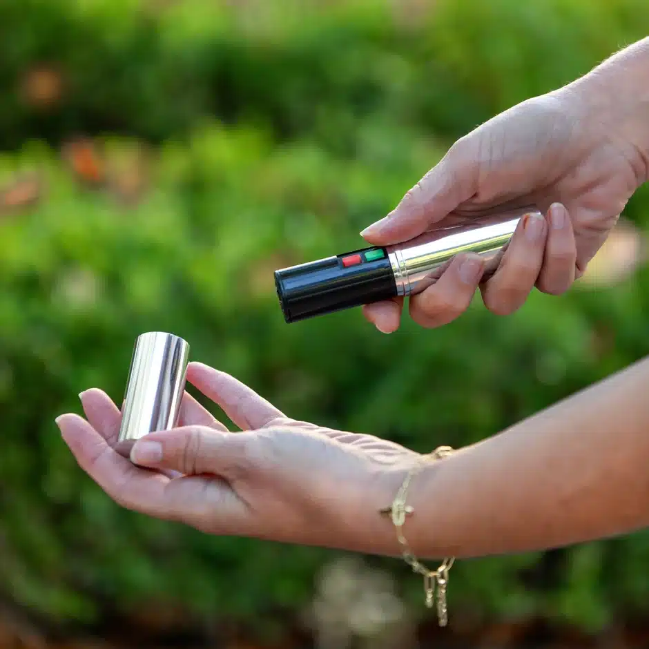 Black cylindrical stun device standing upright